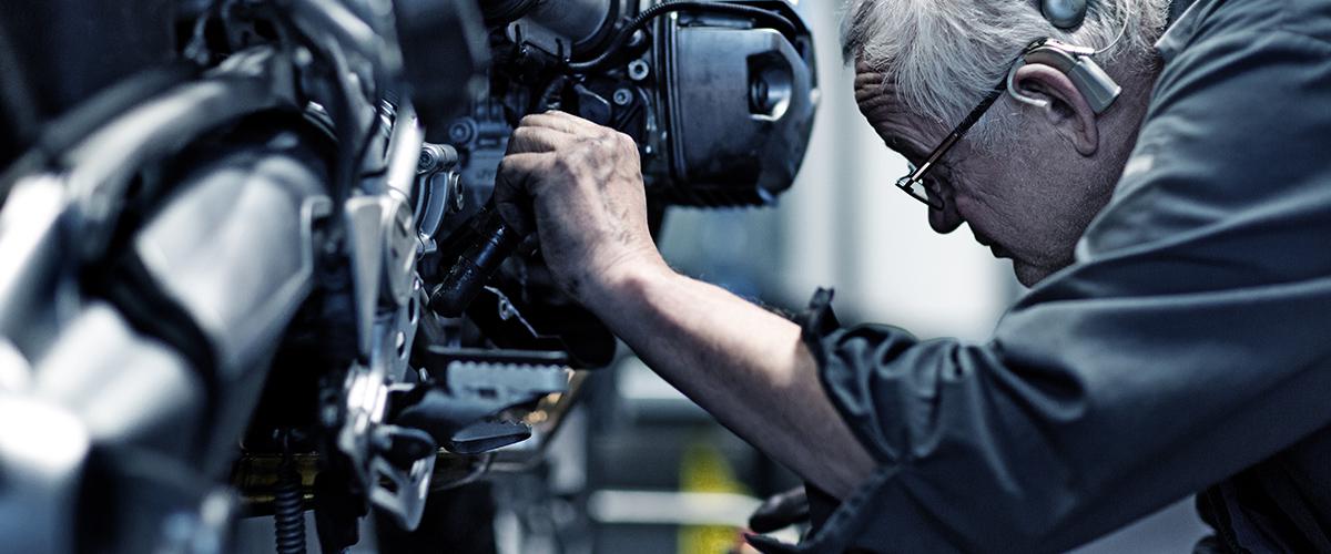 Person servicing motorcycle